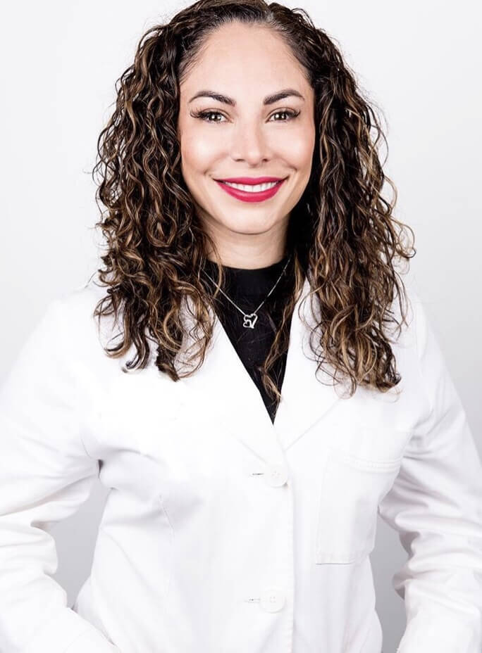 Aesthetician in a white coat smiling, portrait